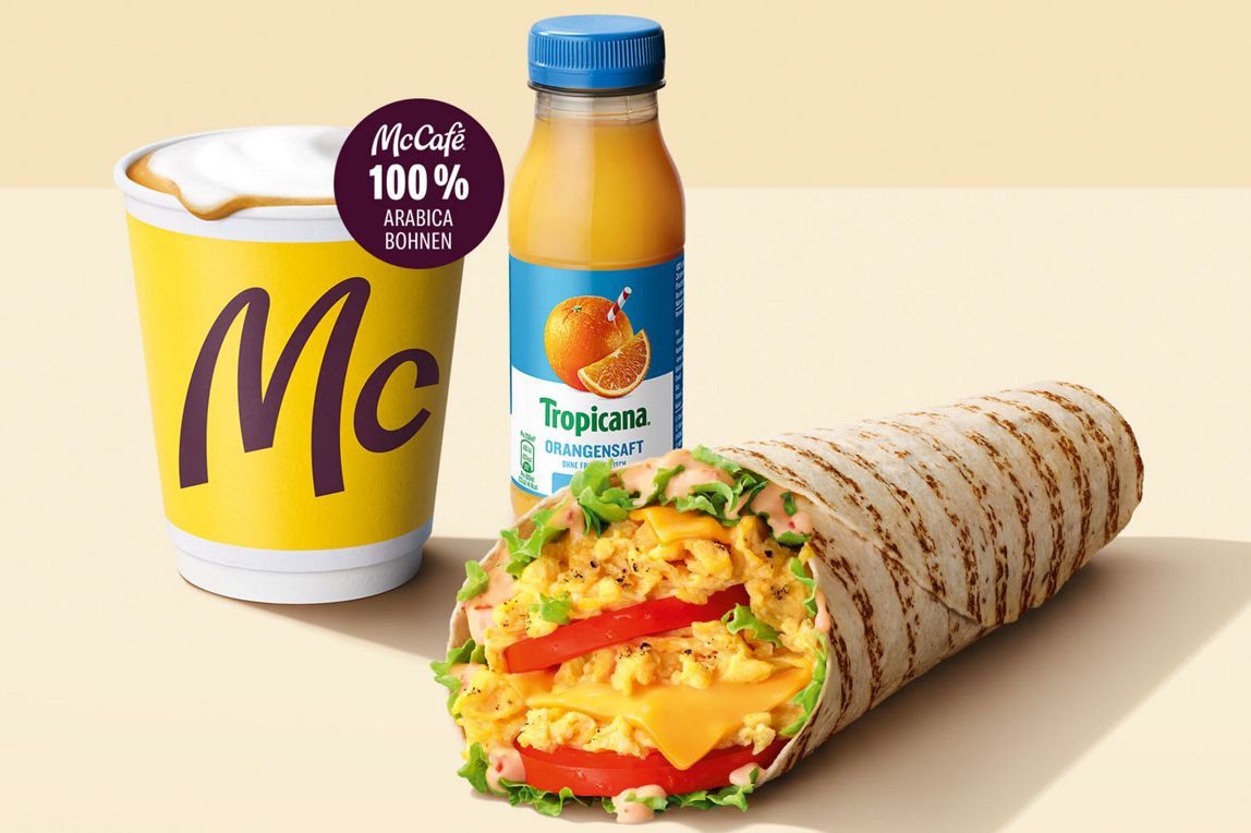 Das Bild zeigt einen Orangensaft, Cappuccino und McWrap® Cheese.