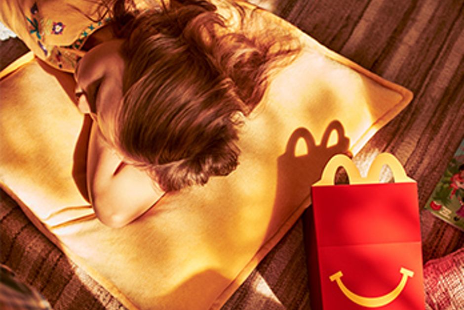 Bild eines Happy Meal und einer Frau mit dem Kopf auf einem Kissen