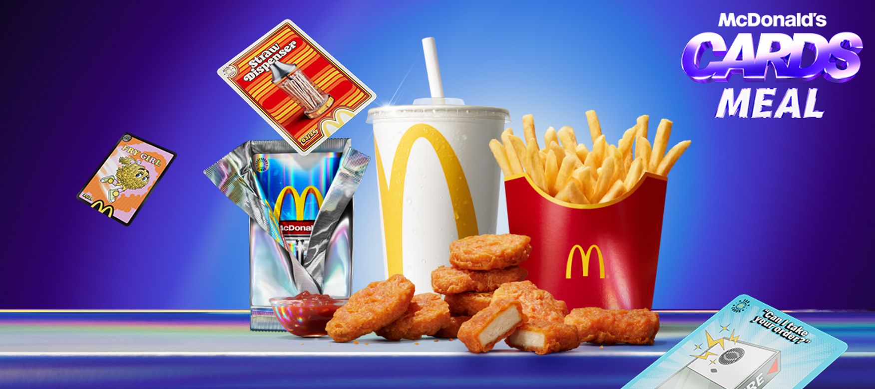 Nine spicy chicken McNuggets with fries and a drink, arranged on a blue surface with Cards Meal branding in the background.
