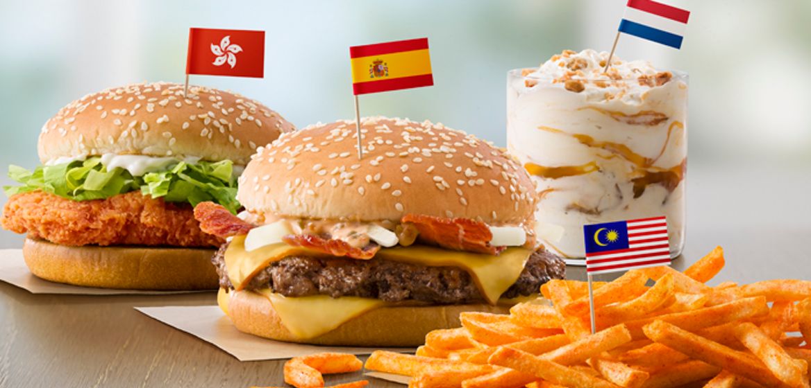 Flavors from Abroad / Taste of the World (left to right): Hong Kong's McSpicy Chicken Sandwich, Spain's Grand McExtreme Bacon Burger, Malaysia's BBQ McShaker Fries and Netherlands' Stroopwafel McFlurry.  Drive Thru Translite.