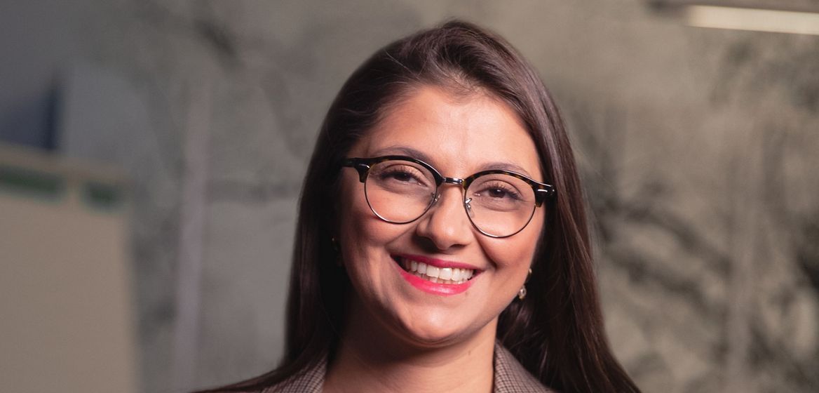 A smiling woman in a suit jacket