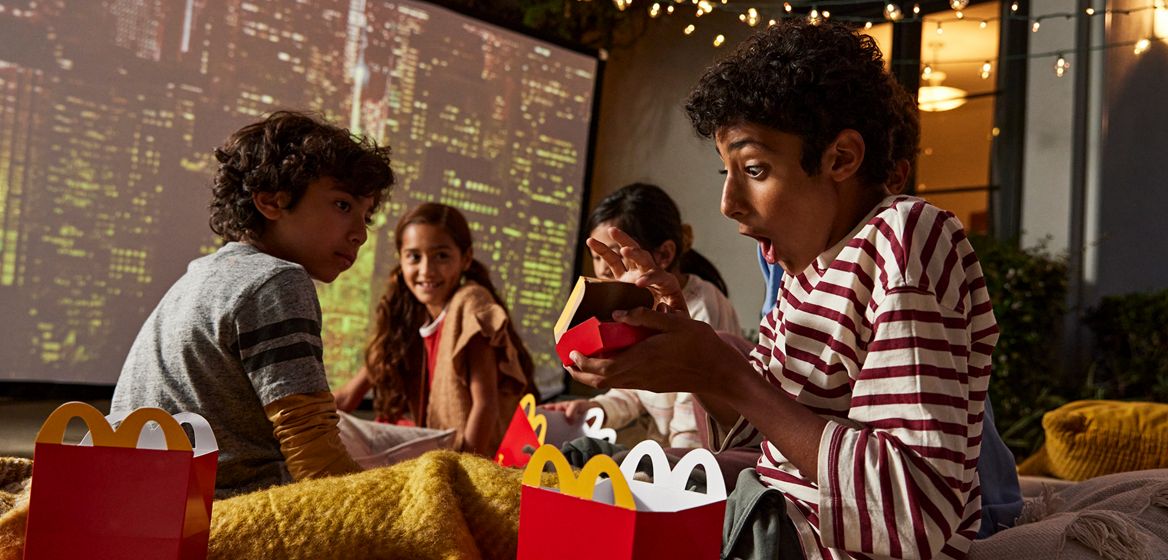 Children with Happy Meal boxes, excited