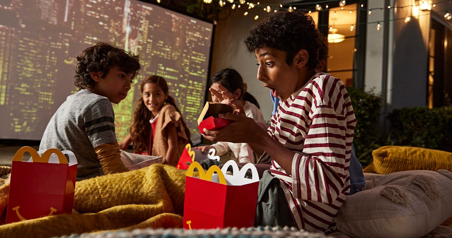 Children with Happy Meal boxes, excited