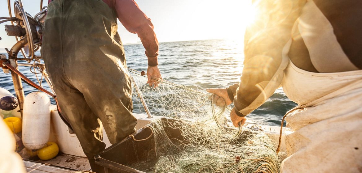 Fishermen holding a fishing net