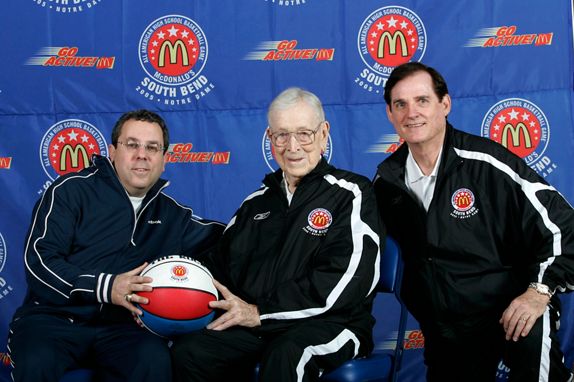 John Wooden (middle) and Bob Geoghan (right) posing with a guest at the 2005 McDonald’s All American Games in South Bend, Indiana; Photo by Brian Spurlock/McDonald’s