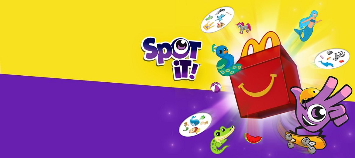 Des icônes et des cartes jaillissent d’une boîte de Joyeux festin avec l’inscription « Spot It! » au-dessus.