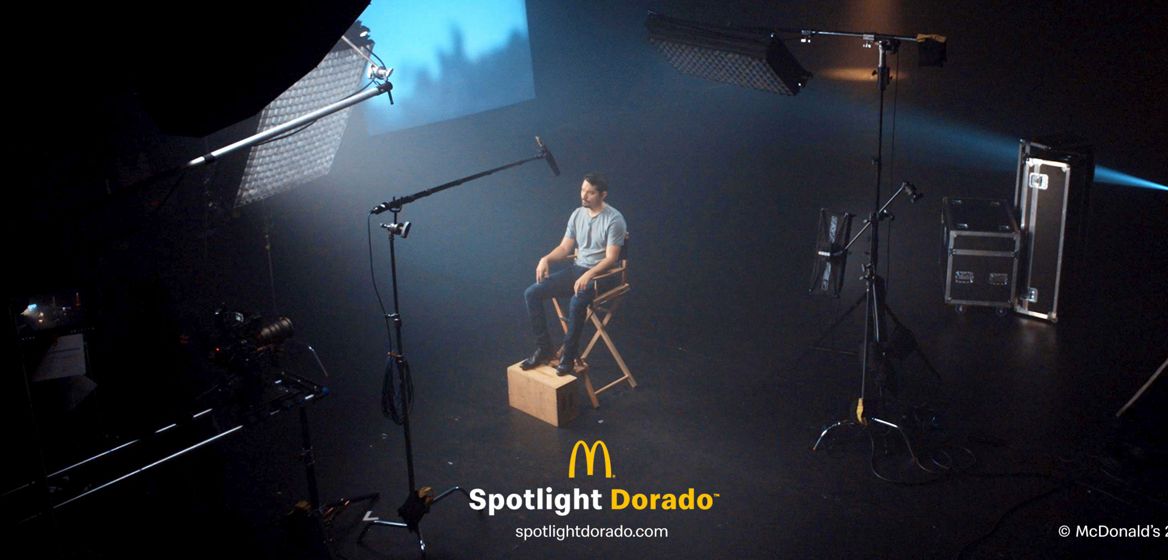 Actor and recording artist Anthony Ramos sitting in a chair in front of cameras