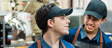 Two McDonald's staff members laughing together