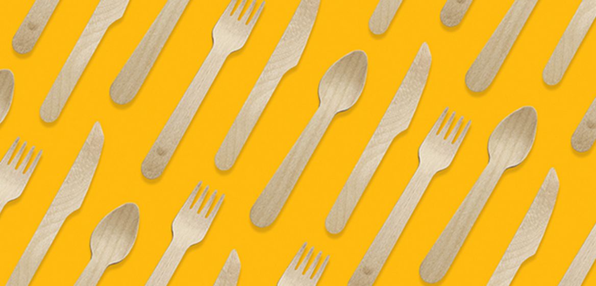 wooden cutlery over a yellow background