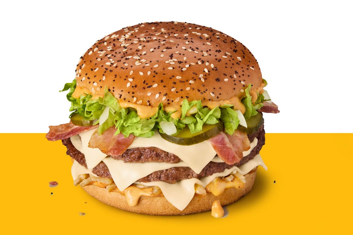 Big Arch burger with two beef patties, cheese slices, bacon, lettuce and pickles in a poppy and sesame seed bun