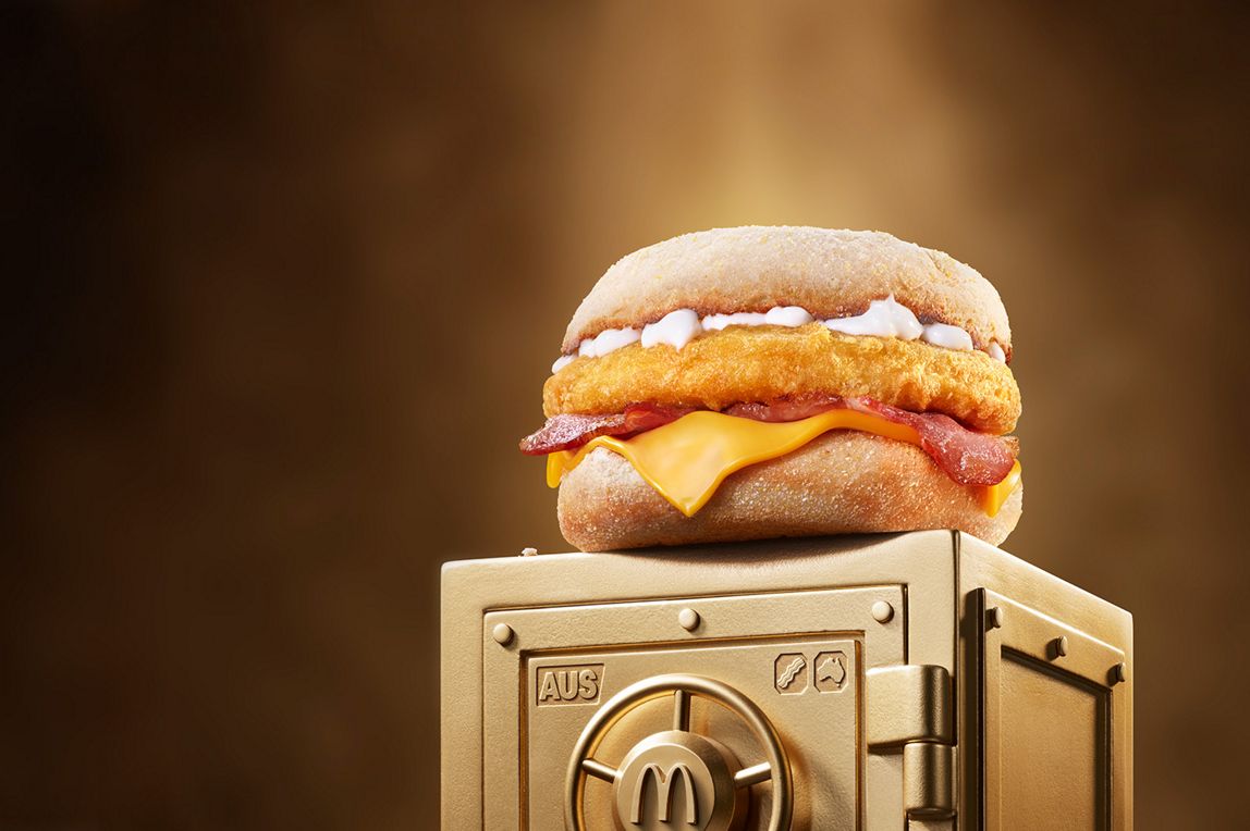 McDonald’s Chicken & Bacon McMuffin® sits on top of a gold vault.