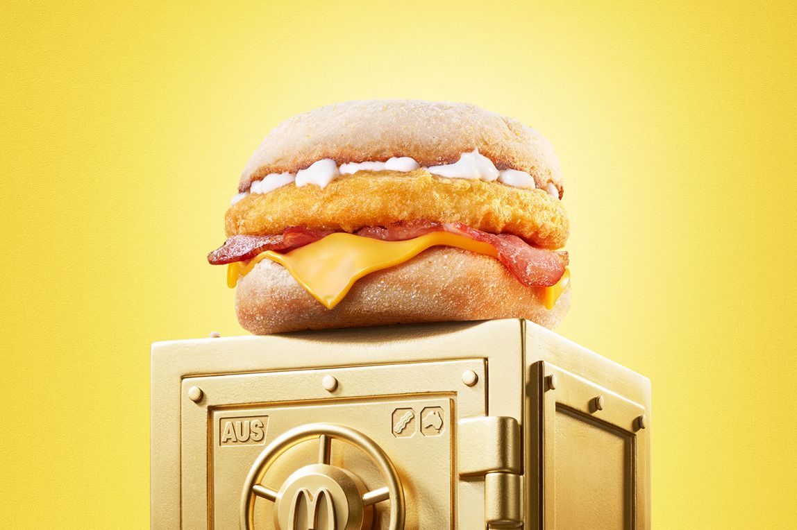 McDonald’s Chicken & Bacon McMuffin® sits on top of a gold vault.