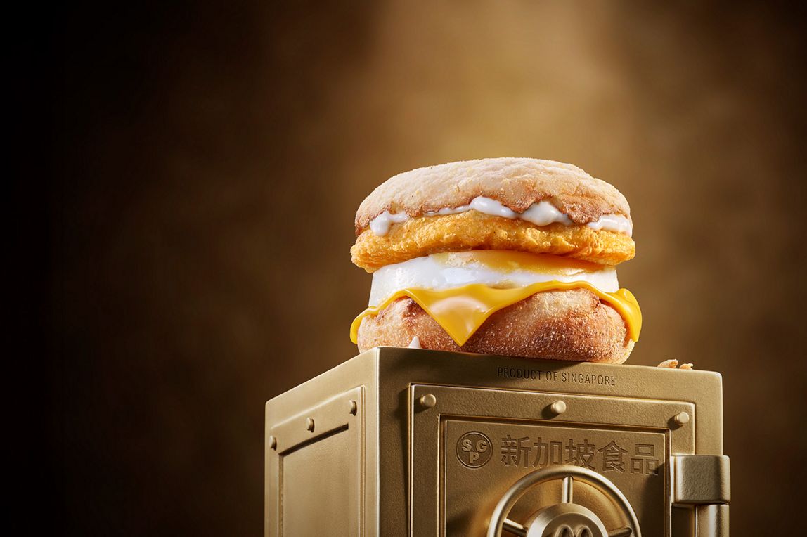 McDonald’s Chicken & Egg McMuffin® sits on top of a gold vault.