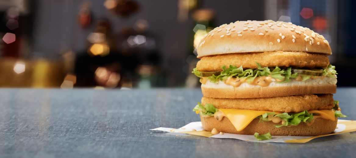 A stacked chicken burger with lettuce, cheese, pickles and Big Mac sauce on a McDonald’s napkin.