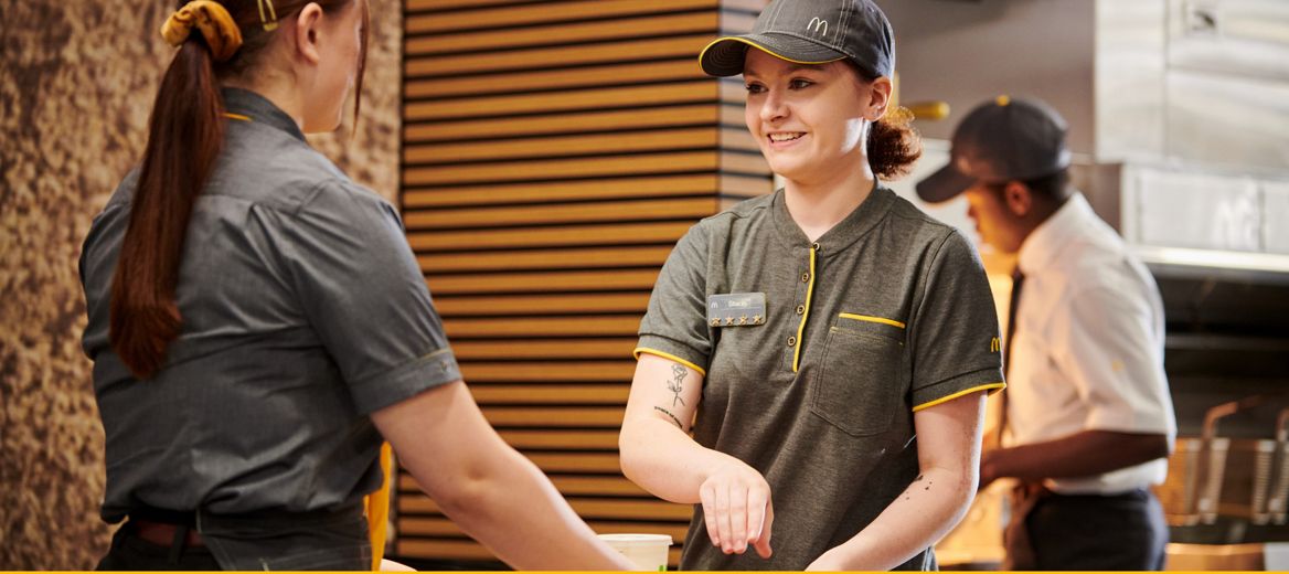 Two McDonald's crew members smiling in McDonald's restaurant