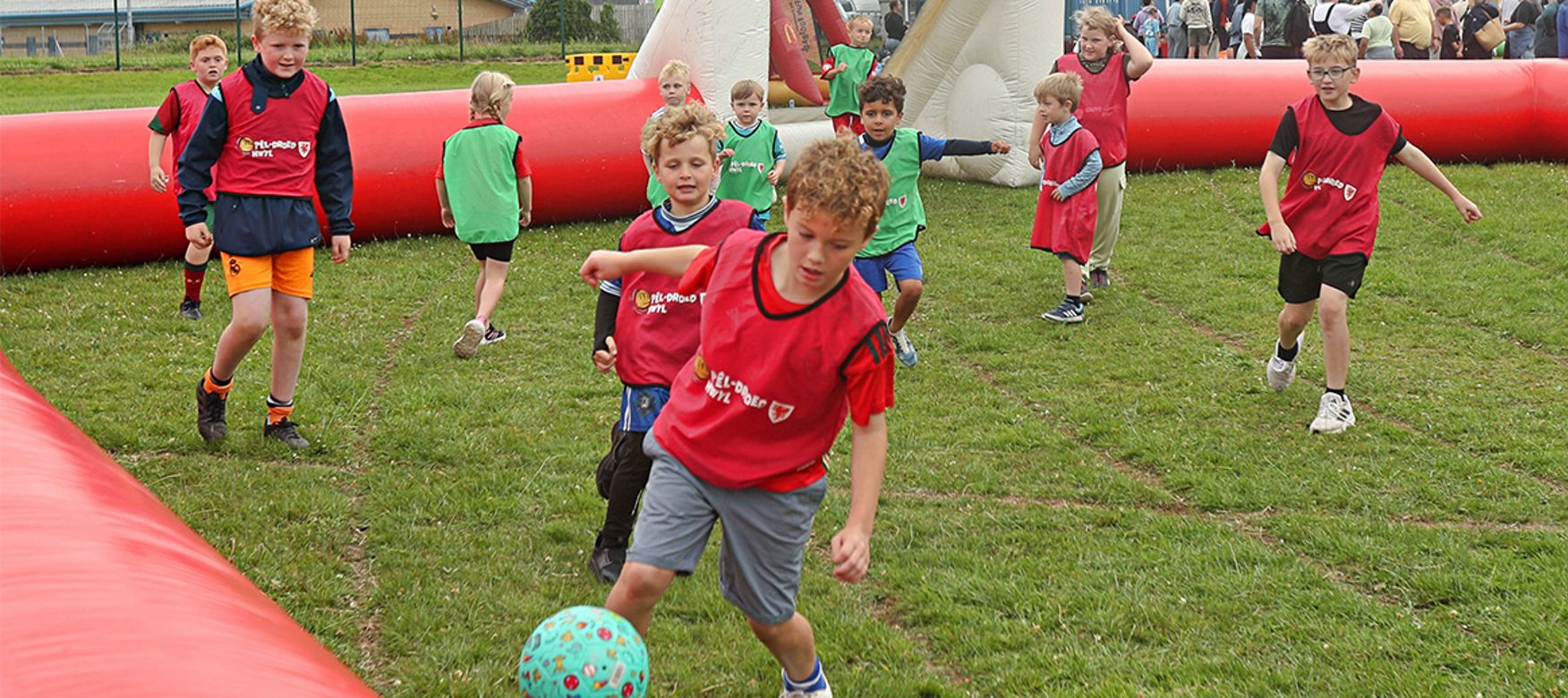 Group of kids celebrating holding a Fun Football banner.