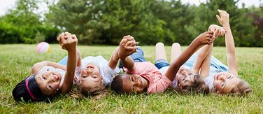 Children in a field smiling