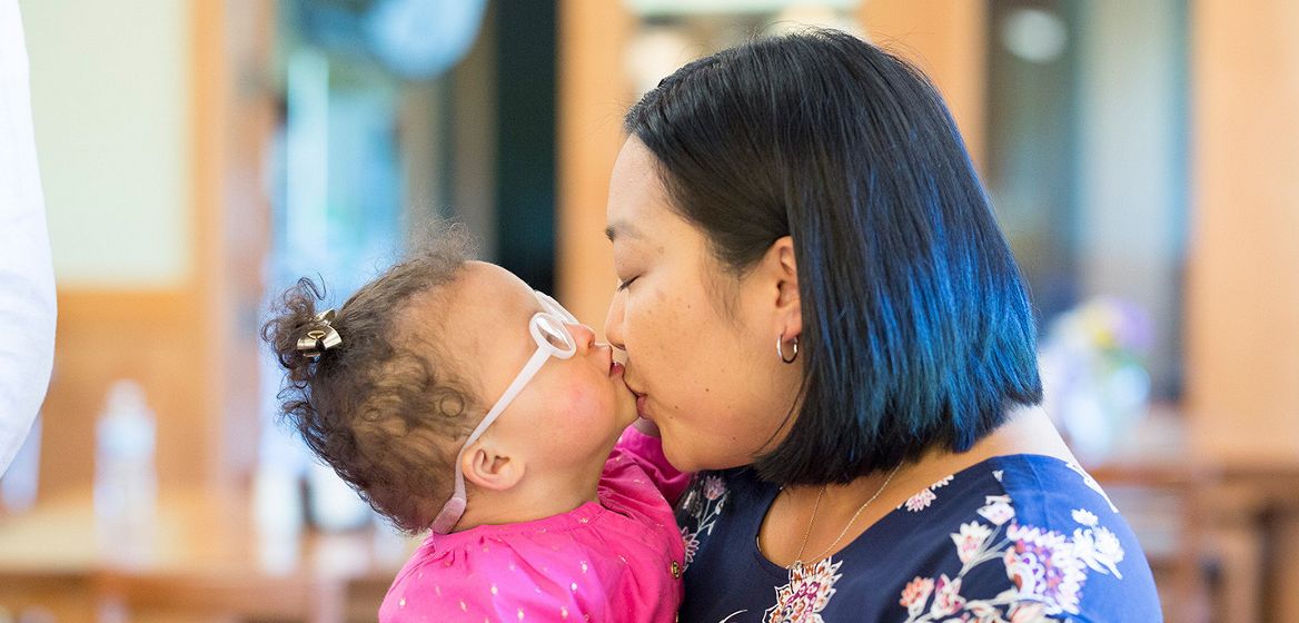 A woman kissing a child