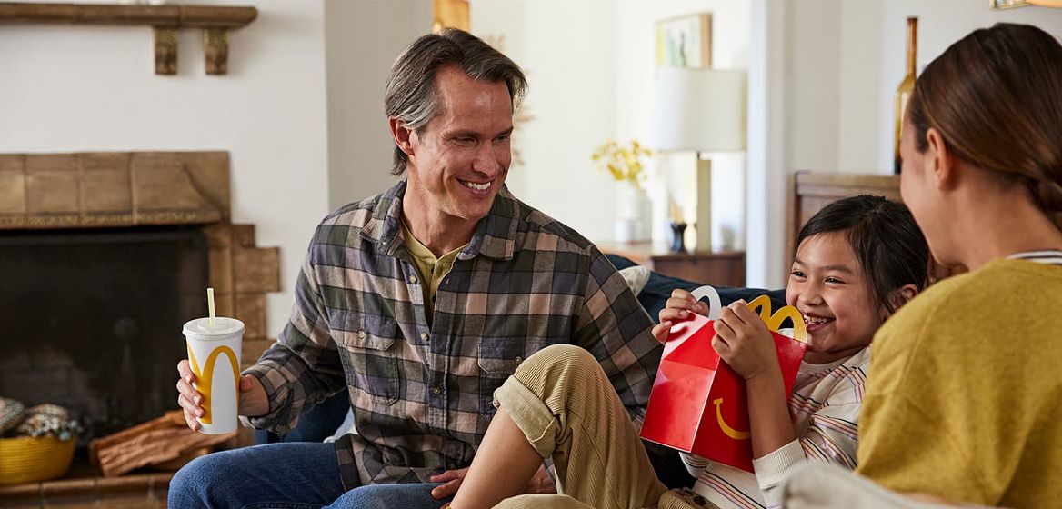 A family sitting and enjoying McDonald's together