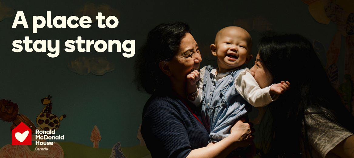 An image of two women holding up a smiling baby next to the words “A place to stay strong”. 