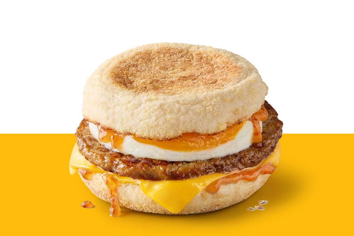 Sausage and egg McMuffin topped with melted cheese and Hot Honey sauce.