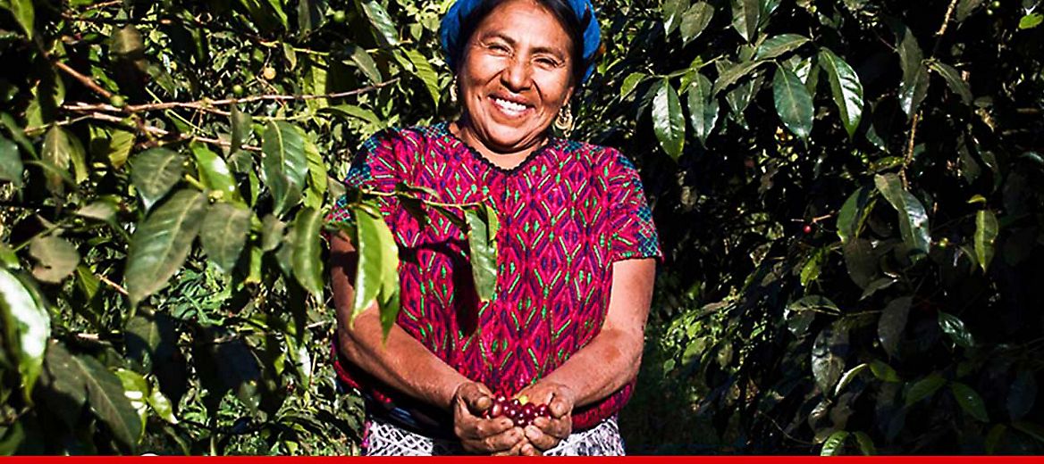 Farmer smiling with her crops.