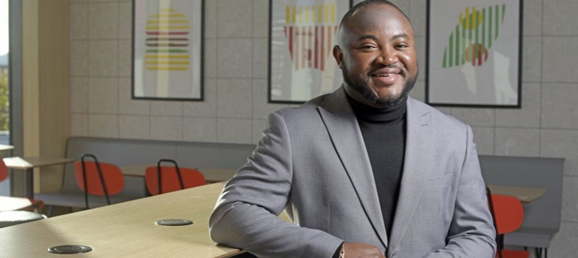 Multi-site franchisee Joey Antwi-Kusi sitting in one of his restaurants.