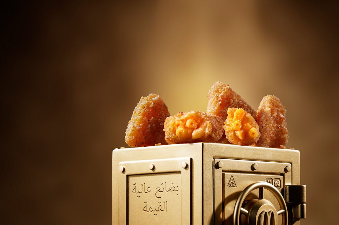 : McDonald’s Mac & Cheese Triangles sits on top of a gold vault.