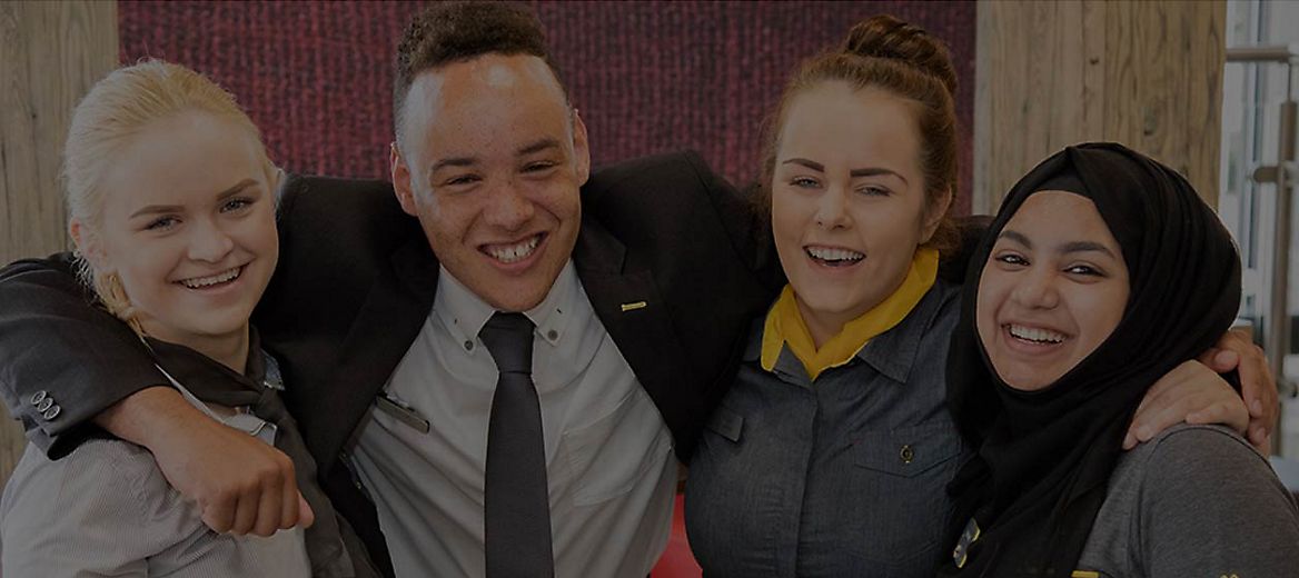 Group of McDonald’s employees smiling at camera