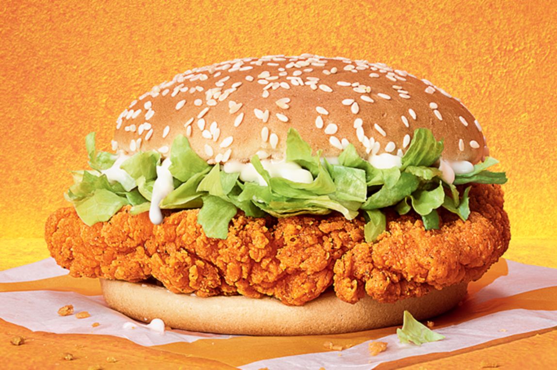 Crispy coated golden chicken breast, with crunchy lettuce and a creamy sauce, on a sesame seeded golden bun.