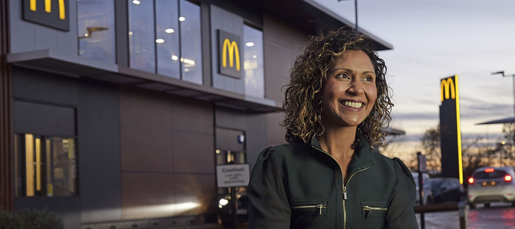 McDonald’s franchisee Shameela Awan-Patel outside a restaurant at dusk.
