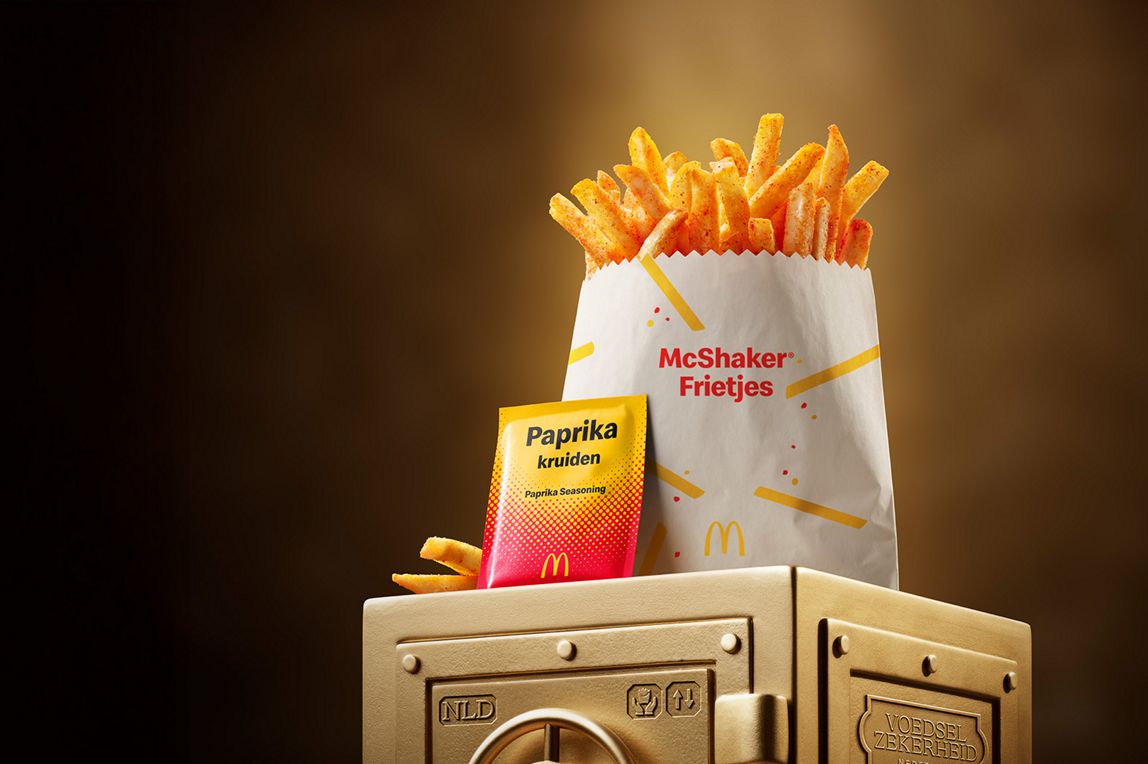 McDonald’s Paprika McShaker® Fries sits on top of a gold vault.