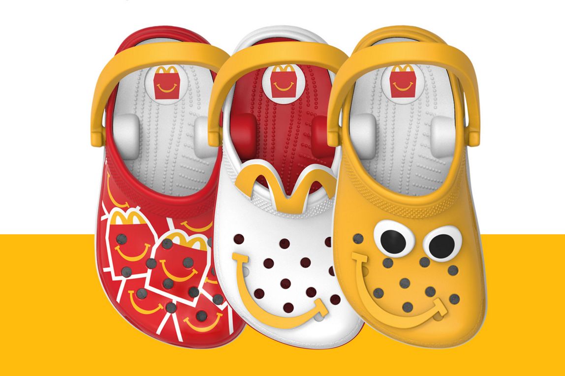 Three Crocs-themed toy clogs in red, white and yellow displayed side by side.