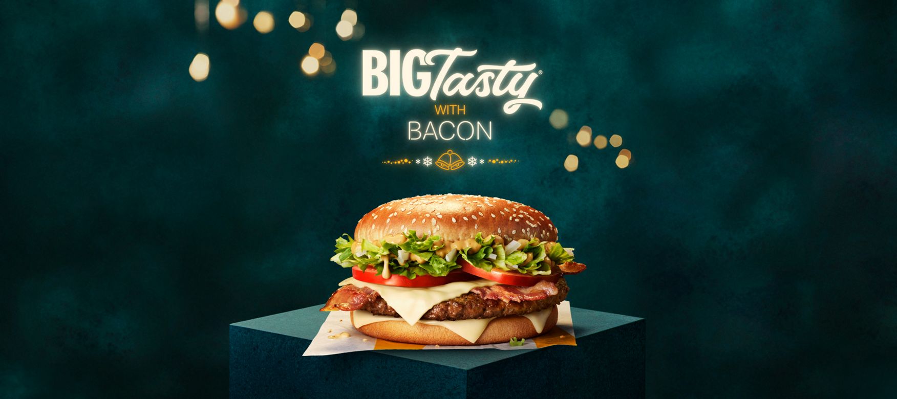 Big Tasty® (with bacon) with a festive dark green background