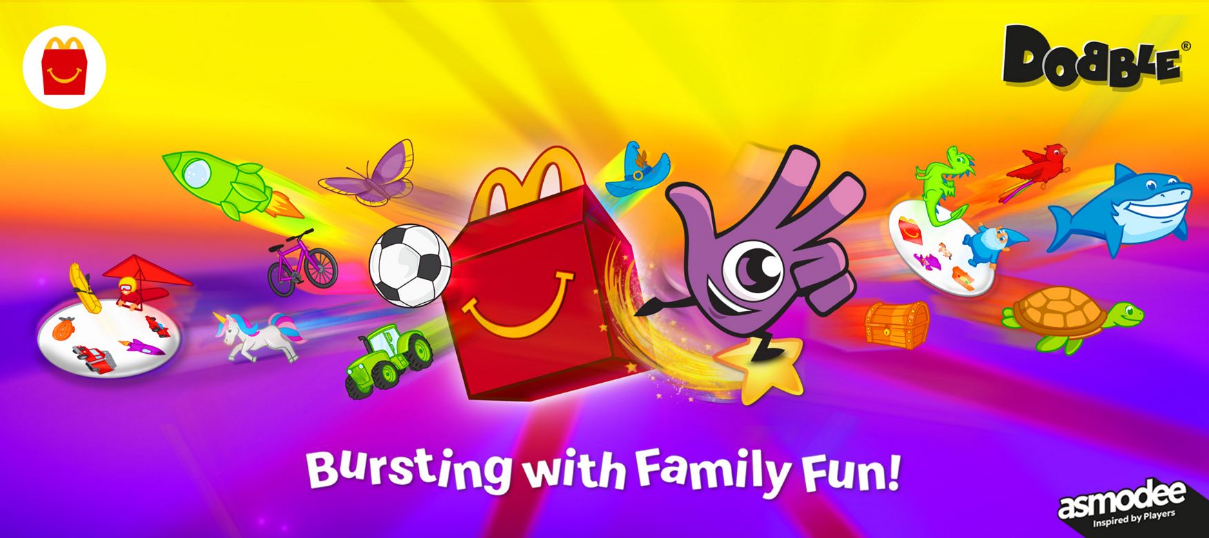 A bright, colourful scene with the Dobbly and a Happy Meal box    surrounded by flying illustrated objects like rockets, animals, bikes and    treasure chests.  