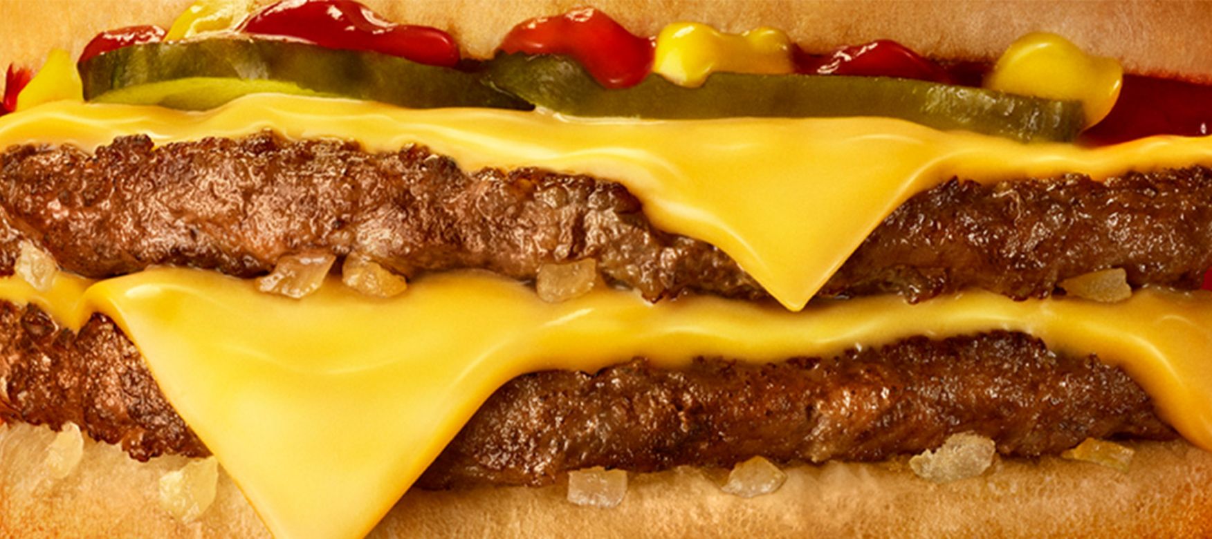 Close up of a Double Quater Pounder with  melting cheese oozing out of the burger