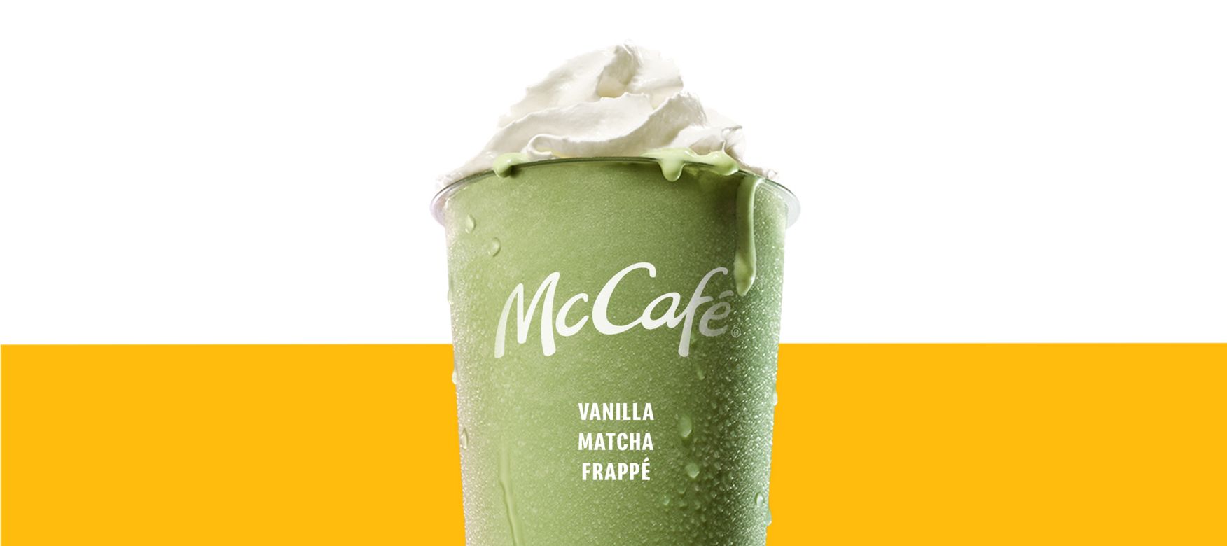 Vanilla Match Frappe in a chilled McCafé cup, topped with whipped cream and against a yellow background
