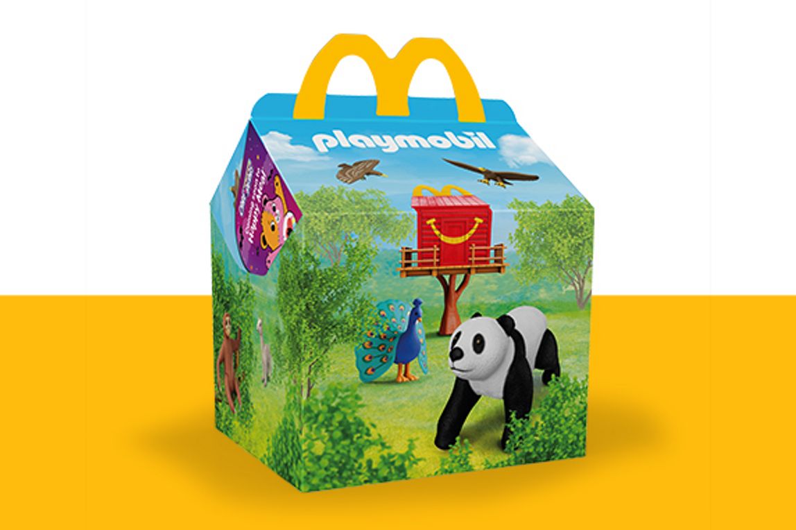 Squishmallows characters on a Happy Meal box on a yellow shelf  