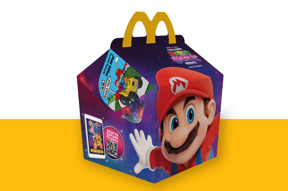 Super Mario on a galaxy background on the Happy Meal box on a yellow shelf