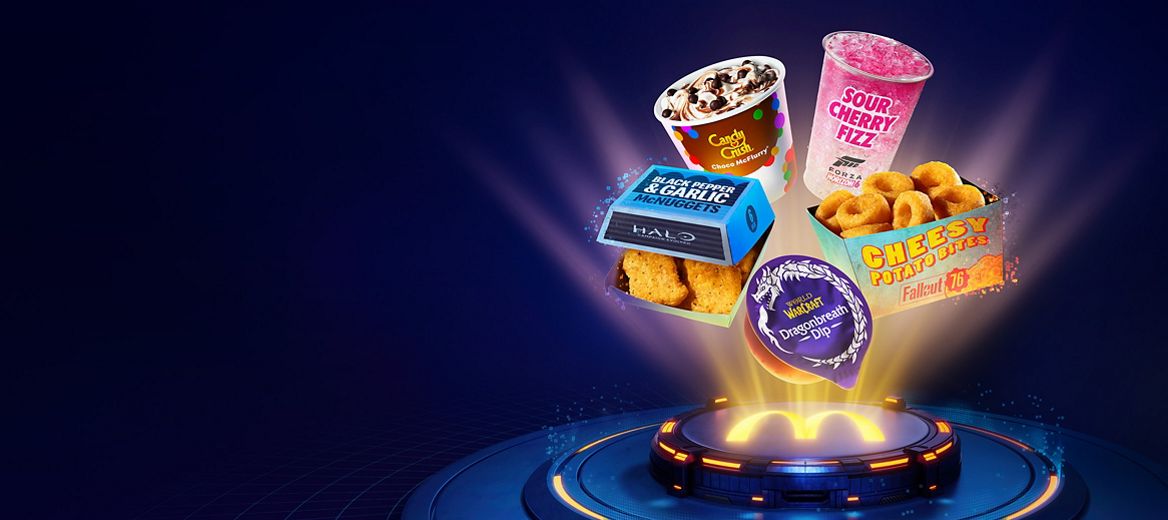 Collection of promotional McDonald's menu items floating above a glowing McDonald's platform, including a Candy Crush Choco McFlurry, Sour Cherry Fizz drink, Cheesy Potato Bites, Black Pepper and Garlic McNuggets, and World of Warcraft Dragonbreath Dip.