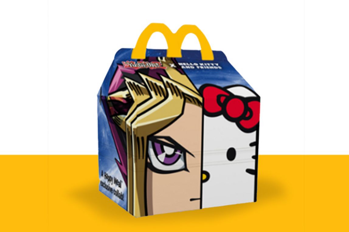 Yu-Gi-Oh x Hello Kitty combined themed Happy Meal box on a  yellow shelf.