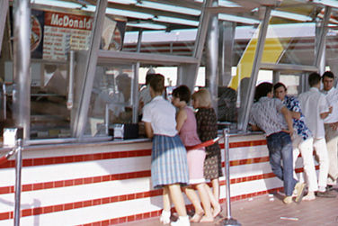 Several people ordering food at the first McDonald's storefront