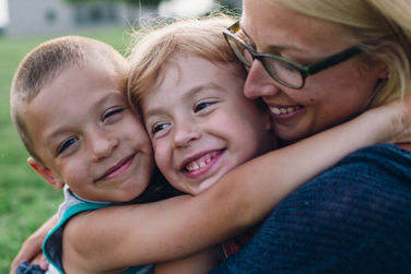 Mother hugging daughter and son