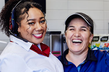 2 McDonald's staff members smiling together