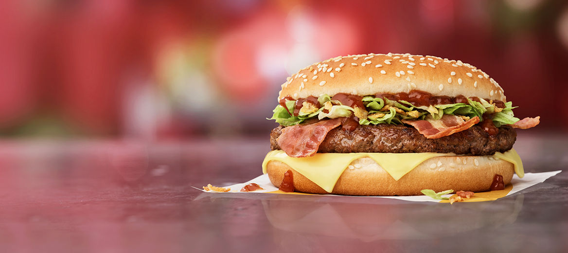 Picture of the Big Tasty® BBQ with beef, cheese, onions, brown BBQ sauce on a golden bun.