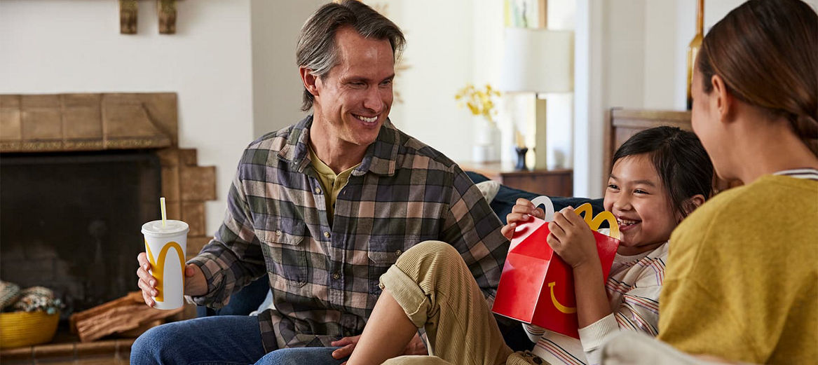 A family sitting and enjoying McDonald's together