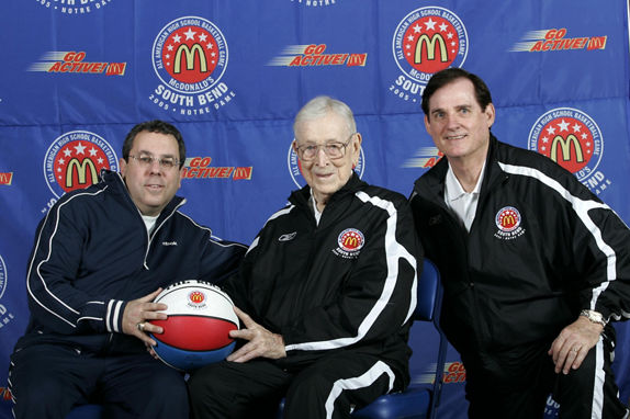 John Wooden (middle) and Bob Geoghan (right) posing with a guest at the 2005 McDonald’s All American Games in South Bend, Indiana; Photo by Brian Spurlock/McDonald’s
