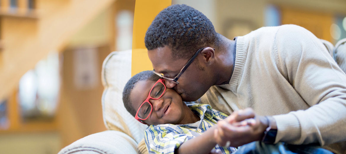A man kissing and embracing a child