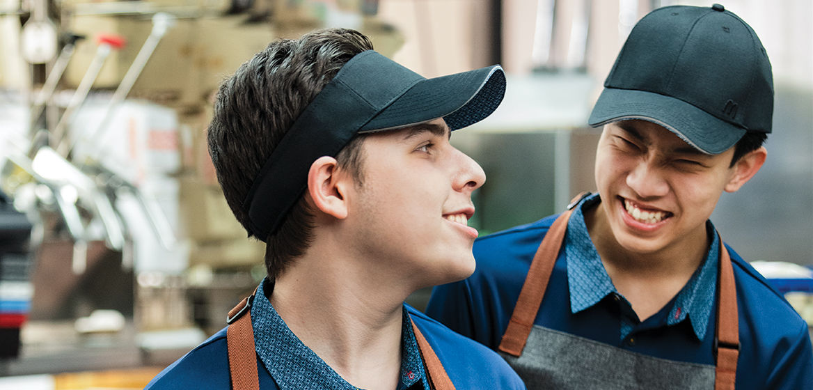 Two McDonald's staff members laughing together