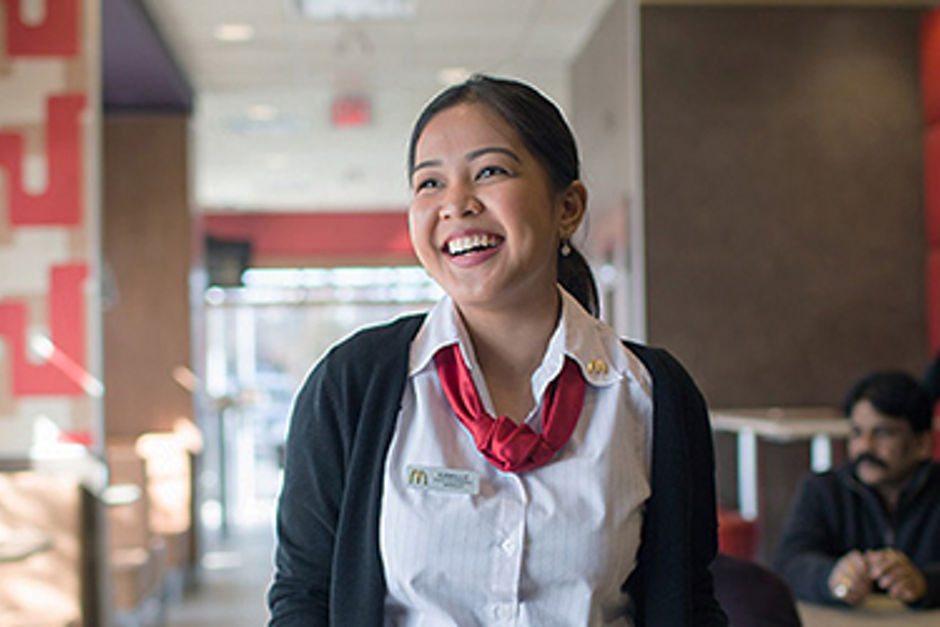 McDonald's Staff member cheerily serving a tray food